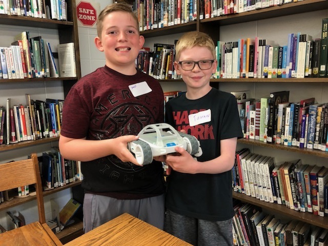 two students posing with their RVR robot